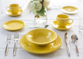 Yellow dining table set at Amica senior living residence.