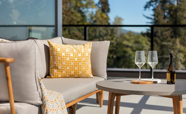 ArbutusRidge-home-outdoor_patio_with_couch_and_wine_glasses_with_balcony_in_the_background ArbutusRidge-home-outdoor_patio_with_couch_and_wine_glasses_with_balcony_in_the_background