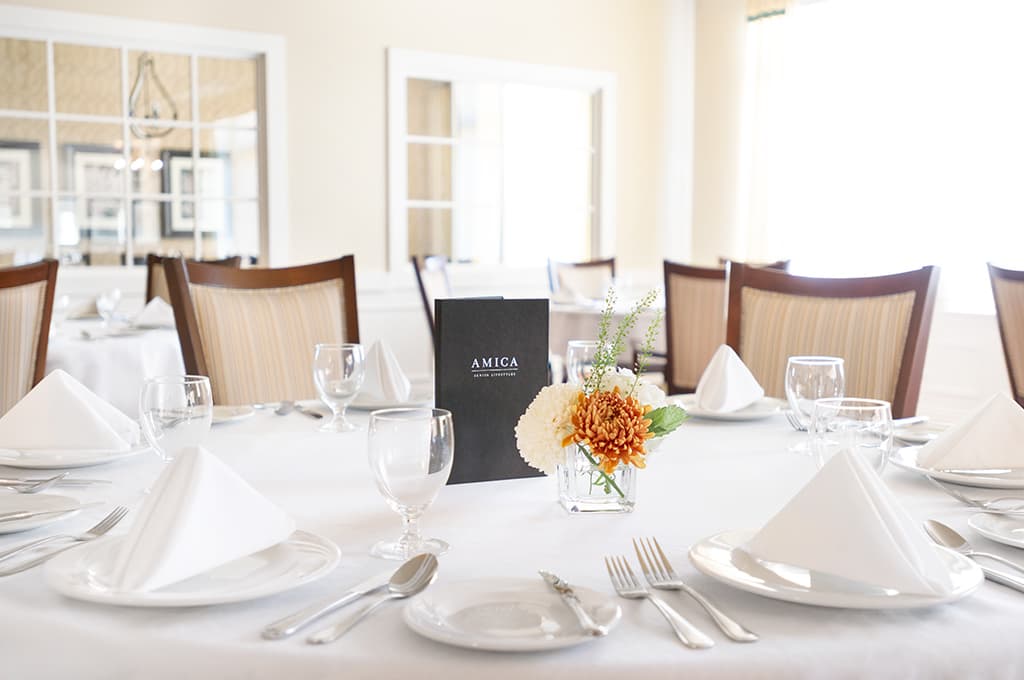 Stoney Creek Main - Dining Room 2 Amica Stoney Creek retirement living residence dining room with floral setup.
