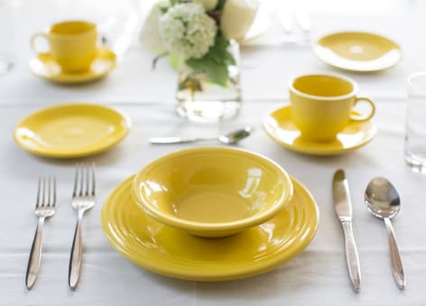 MC_diningFPO_760X546 Yellow dining table set at Amica senior living residence.