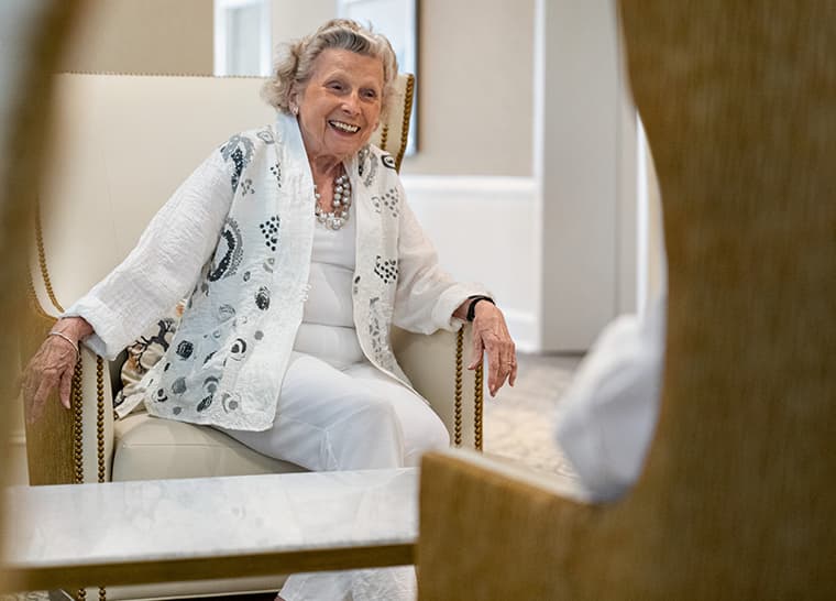 Amica The Glebe - Engage in Social Activities Website Panel Image Happy resident socializing in chair