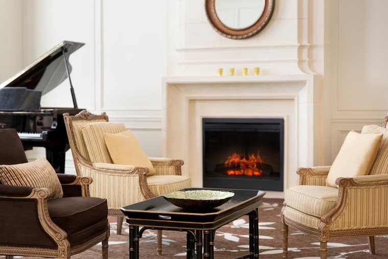 Amica Bayview Gardens - Lobby Fireside - Piano Lobby featuring the armchairs, piano and a fireside.
