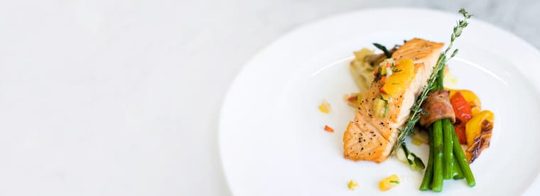 Amica Dining Panel Fade Right Dining photo with salmon and asparagus entree at Amica senior living residence.
