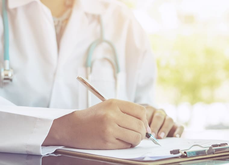 Health-Pros-760x546 Doctor writing in notebook at Amica senior residence.